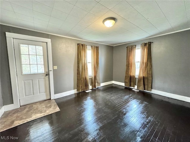 entrance foyer with crown molding, hardwood / wood-style flooring, and a wealth of natural light