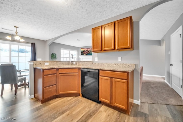 kitchen with sink, light hardwood / wood-style floors, kitchen peninsula, and dishwasher