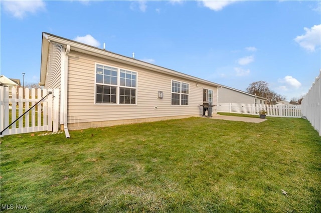 rear view of property featuring a yard