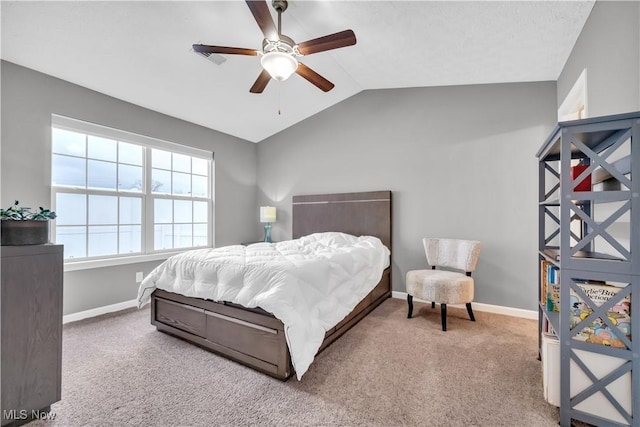 bedroom with ceiling fan, vaulted ceiling, and carpet