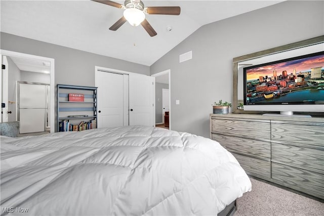 carpeted bedroom with vaulted ceiling, a closet, and ceiling fan