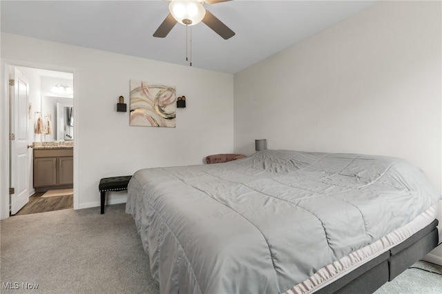 carpeted bedroom with ceiling fan and ensuite bathroom