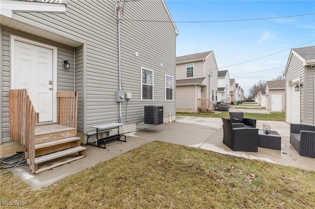 exterior space featuring a patio, an outdoor hangout area, central AC unit, and a lawn