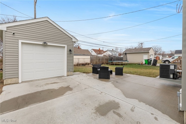 garage with a trampoline and a yard