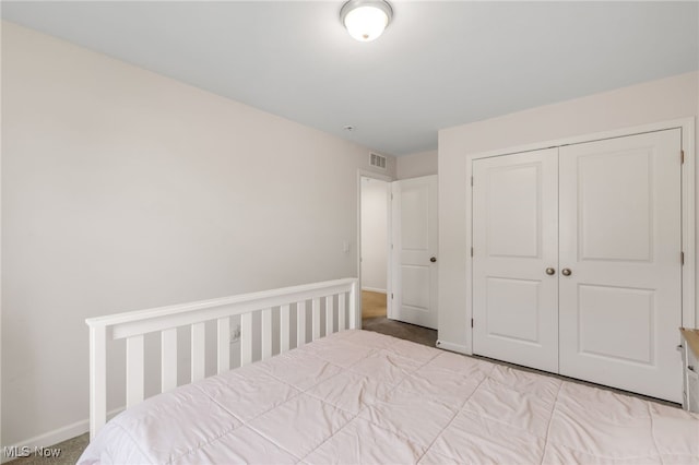 unfurnished bedroom with light colored carpet and a closet