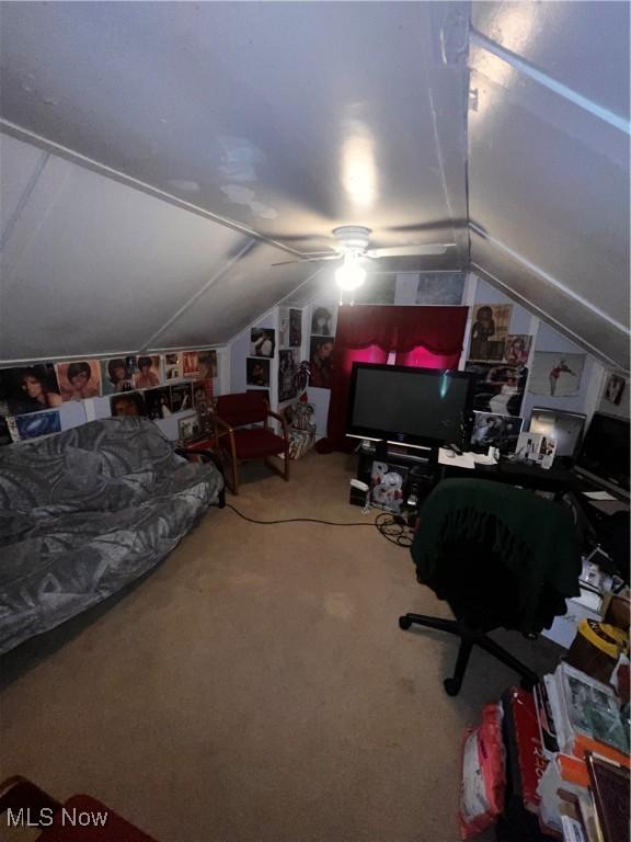 carpeted bedroom with lofted ceiling