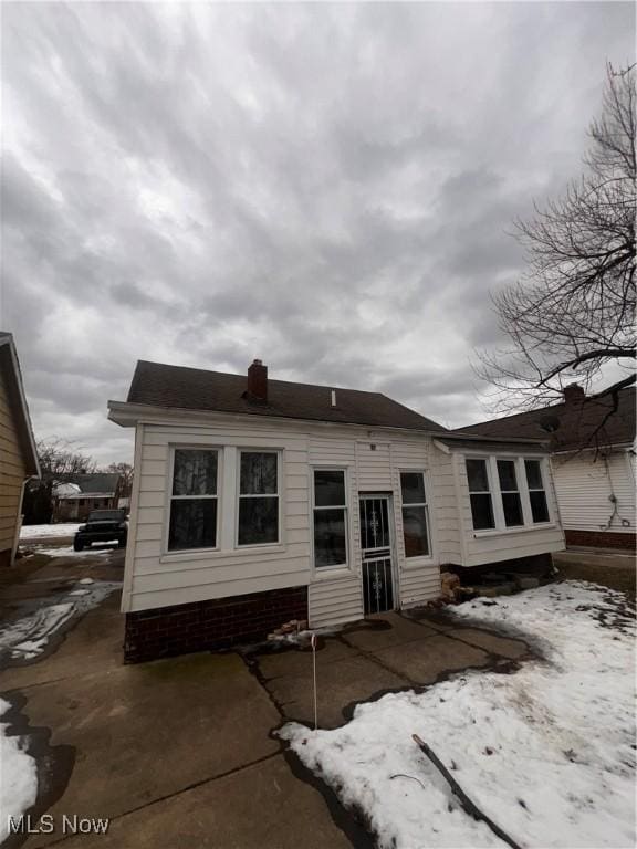 snow covered property with a patio area