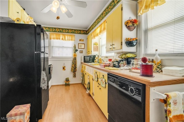 kitchen with ceiling fan, sink, light wood-type flooring, and black appliances