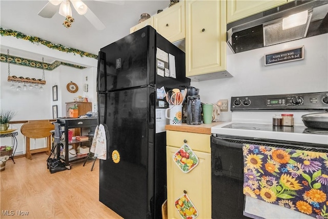 kitchen with exhaust hood, electric range, ceiling fan, black fridge, and light hardwood / wood-style flooring