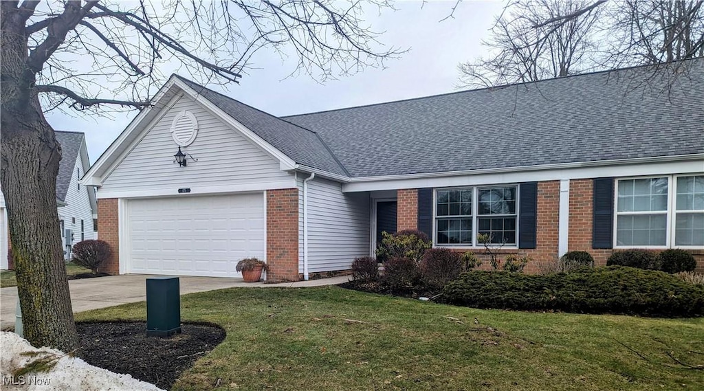 single story home with a garage and a front lawn