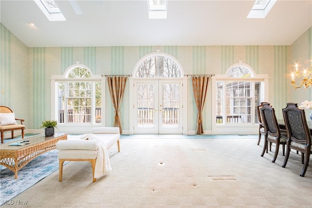 interior space with french doors, a healthy amount of sunlight, and a skylight