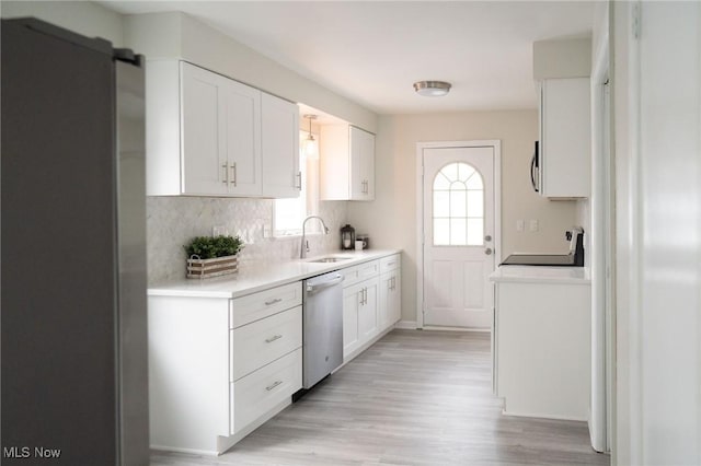 kitchen with white cabinets, sink, dishwasher, and range