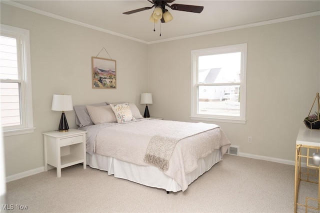 carpeted bedroom featuring ceiling fan and ornamental molding