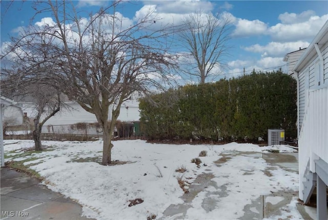 snowy yard with central AC unit