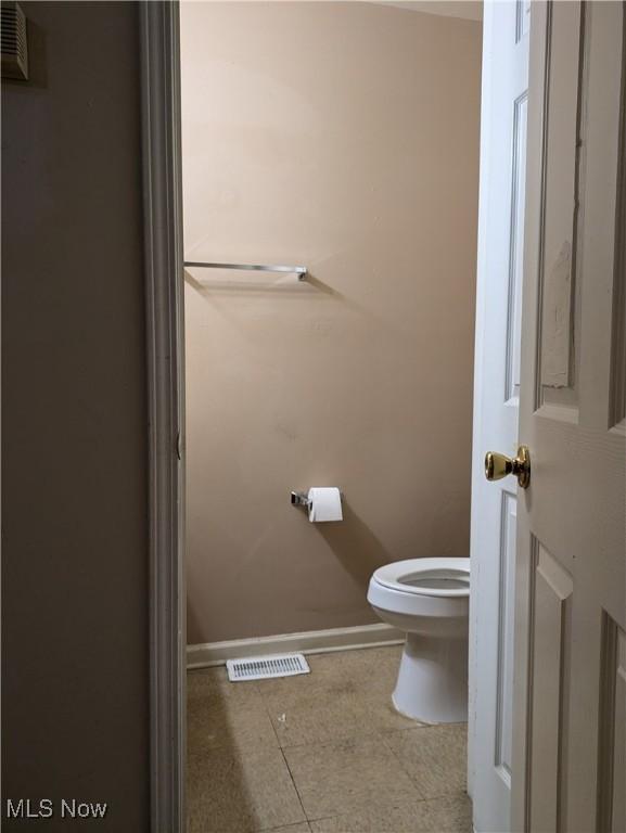 bathroom featuring tile patterned floors and toilet