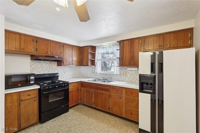 kitchen with tasteful backsplash, sink, black appliances, and ceiling fan