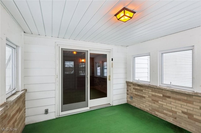 unfurnished sunroom featuring wooden ceiling