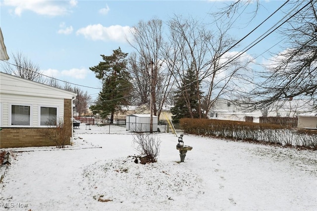 snowy yard with a storage unit