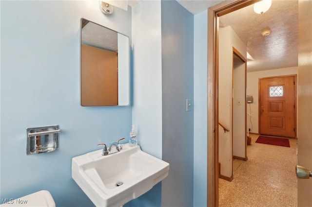 bathroom featuring sink and a textured ceiling