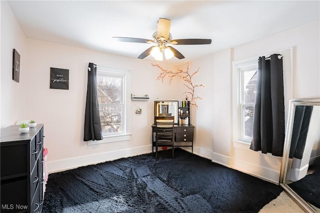 misc room featuring plenty of natural light, ceiling fan, and carpet