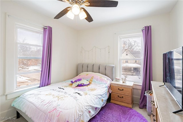 bedroom featuring ceiling fan and light carpet