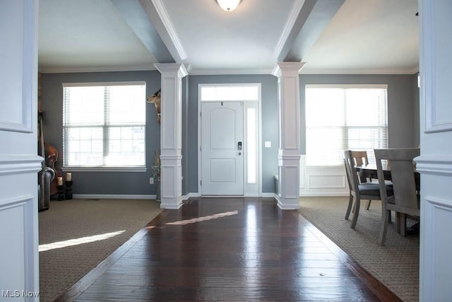 entryway featuring dark hardwood / wood-style flooring, decorative columns, and a wealth of natural light