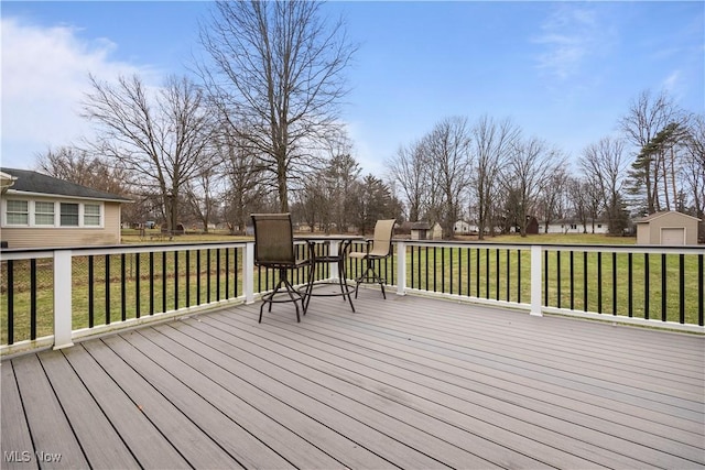 wooden deck featuring a lawn