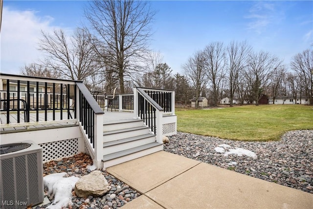 view of yard with a wooden deck and central AC