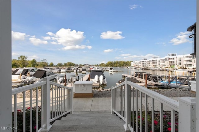 balcony with a dock and a water view