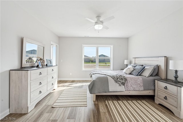 bedroom with light hardwood / wood-style floors and ceiling fan