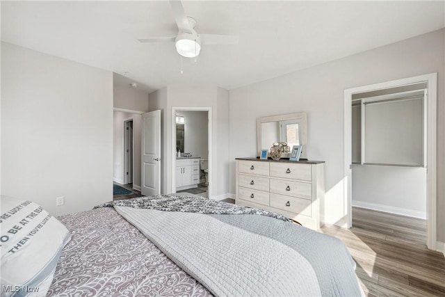 bedroom with ceiling fan, wood-type flooring, and ensuite bathroom