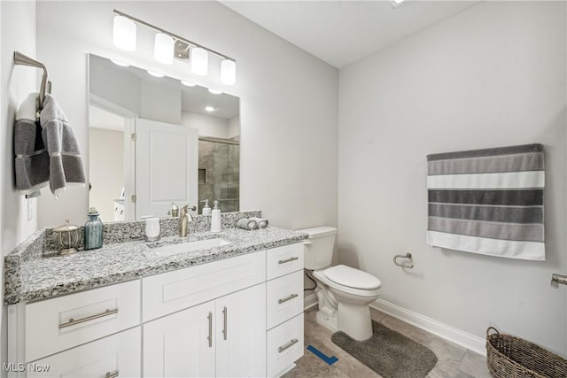 bathroom featuring tile patterned floors, vanity, toilet, and an enclosed shower