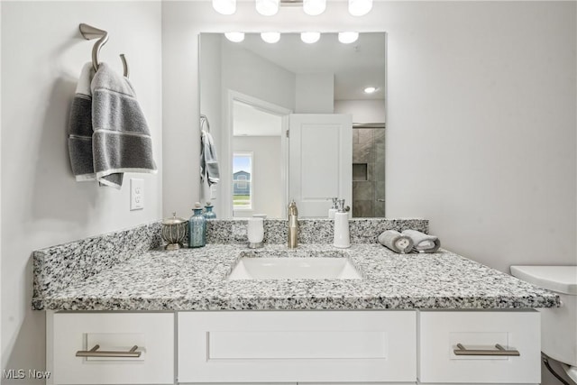 bathroom featuring vanity and toilet