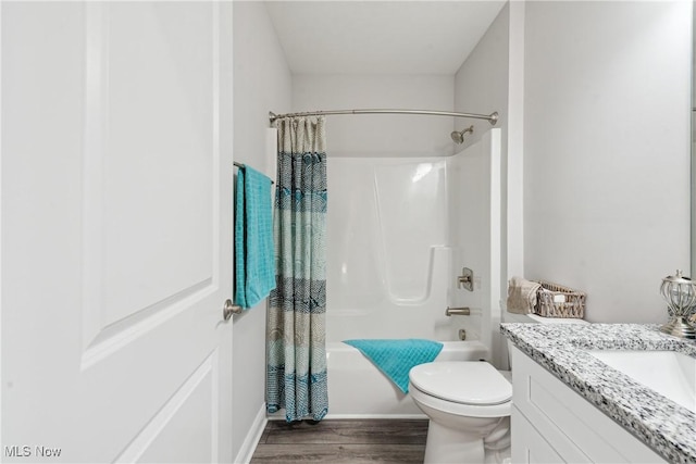 full bathroom with toilet, wood-type flooring, shower / bathtub combination with curtain, and vanity