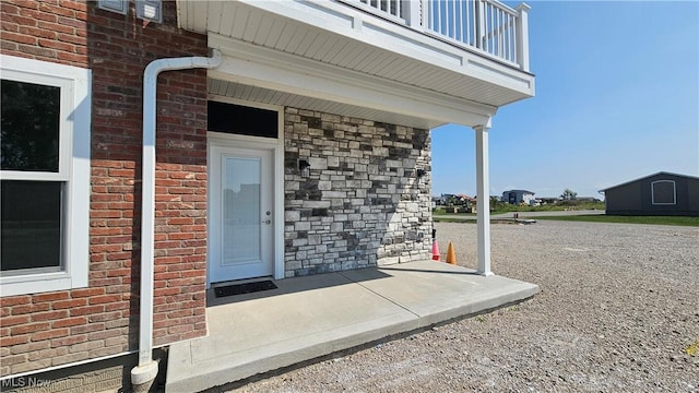 entrance to property with a balcony and a patio area