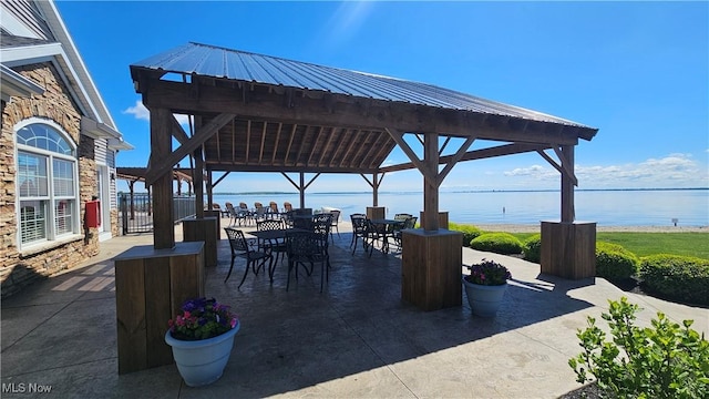 view of patio featuring a gazebo and a water view