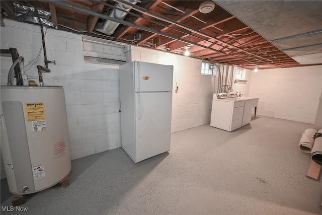 basement with separate washer and dryer, water heater, and white fridge