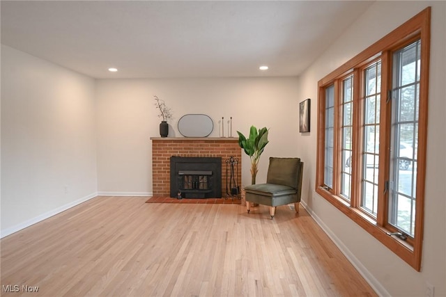 unfurnished room featuring light wood-type flooring and a fireplace