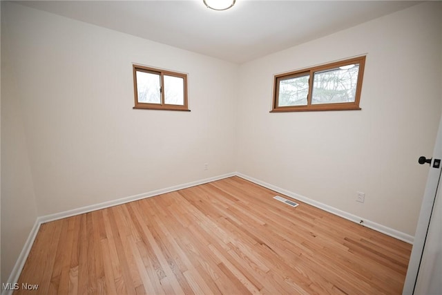 unfurnished room with light hardwood / wood-style flooring and a wealth of natural light