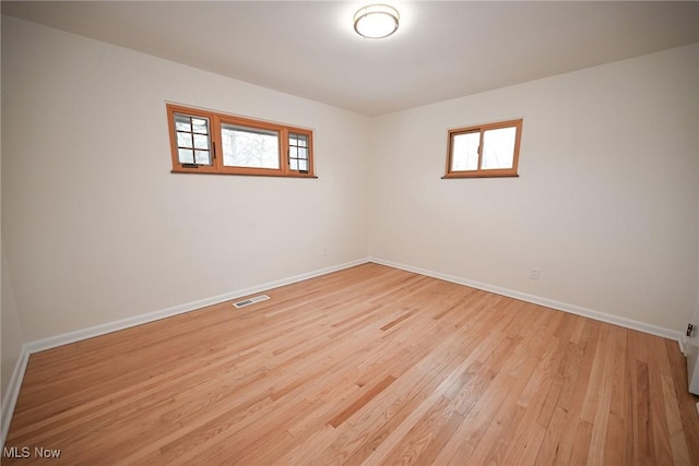 empty room featuring plenty of natural light and light wood-type flooring