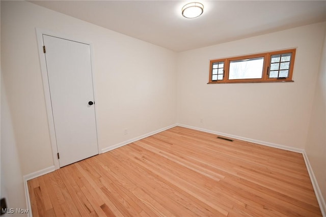 unfurnished room featuring wood-type flooring