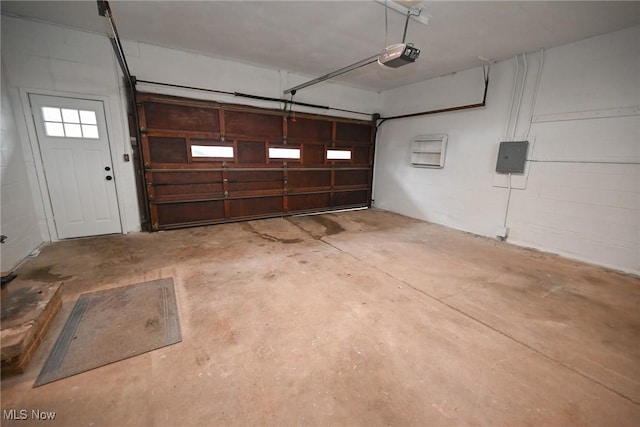 garage featuring a garage door opener and electric panel