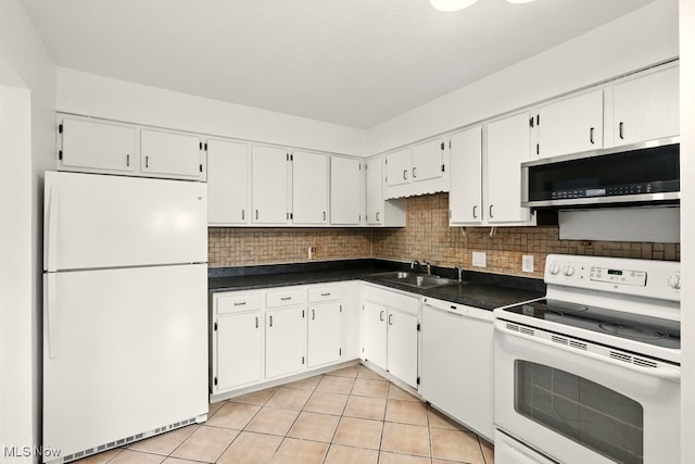 9040 Portage Pointe Dr, Streetsboro, OH 44241 - kitchen featuring white appliances, dark countertops, white cabinets, and light tile patterned flooring