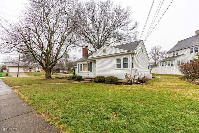 view of property exterior with a garage and a lawn