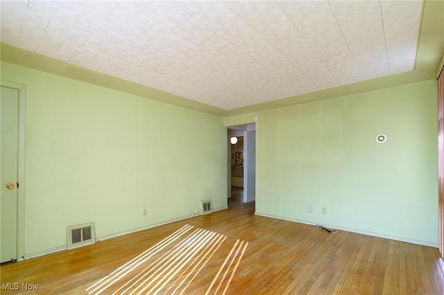 spare room featuring hardwood / wood-style flooring