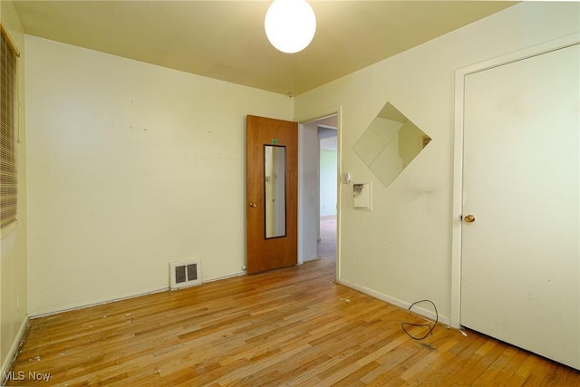 unfurnished room featuring light hardwood / wood-style floors