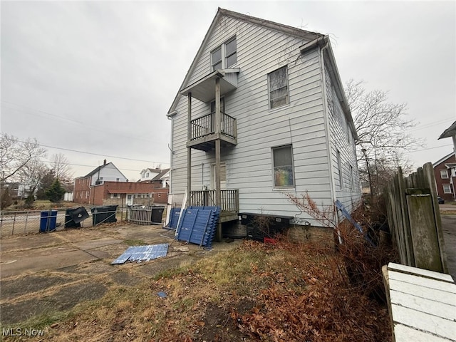 rear view of property featuring a balcony