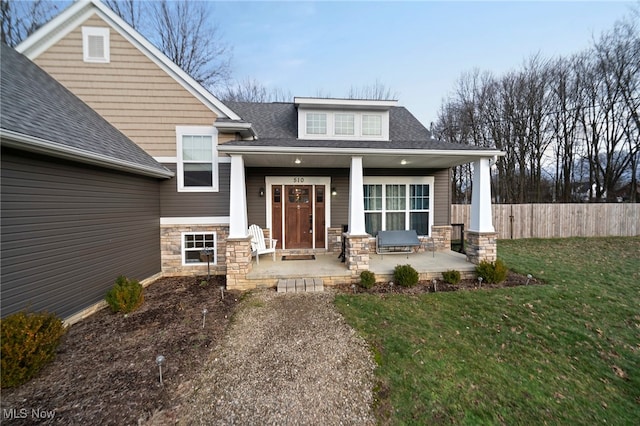 exterior space with a front yard and covered porch