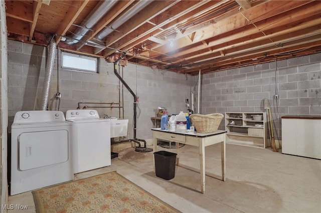 basement featuring sink and washer and dryer