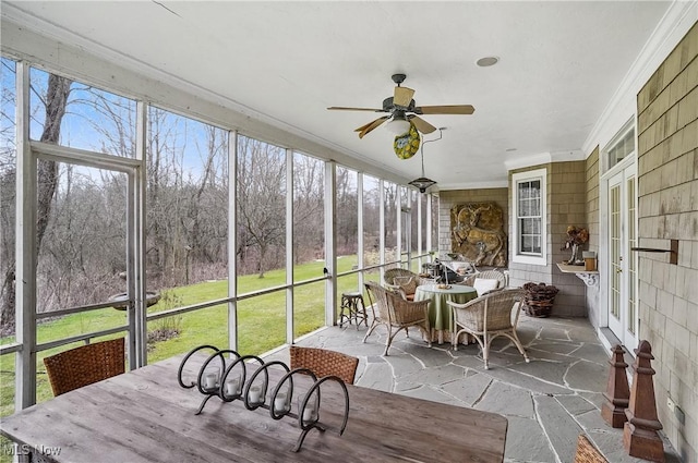 sunroom featuring ceiling fan